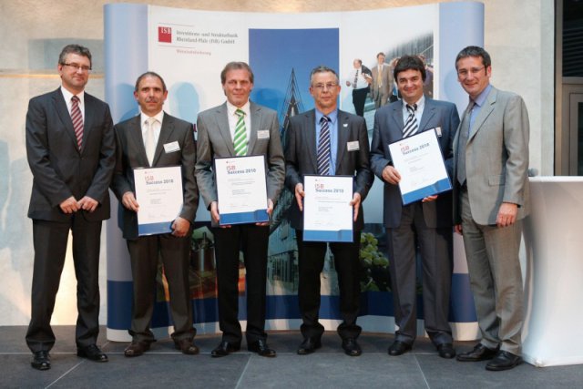 The photo shows the Managing Director of EKU Elektronik GmbH, Hans Erdmann (3. on the right) together with the other awardees during the award ceremony of 09.06.2010 in the foyer of the ISB-building in Mainz given by the Minister for Economics, Transport, Agriculture and Viniculture of the German state Rheinland-Pfalz, Hendrik Hering (right) and Ulrich Dexheimer, Management of the Investitions- und Strukturbank Rheinland-Pfalz (ISB) GmbH (left).